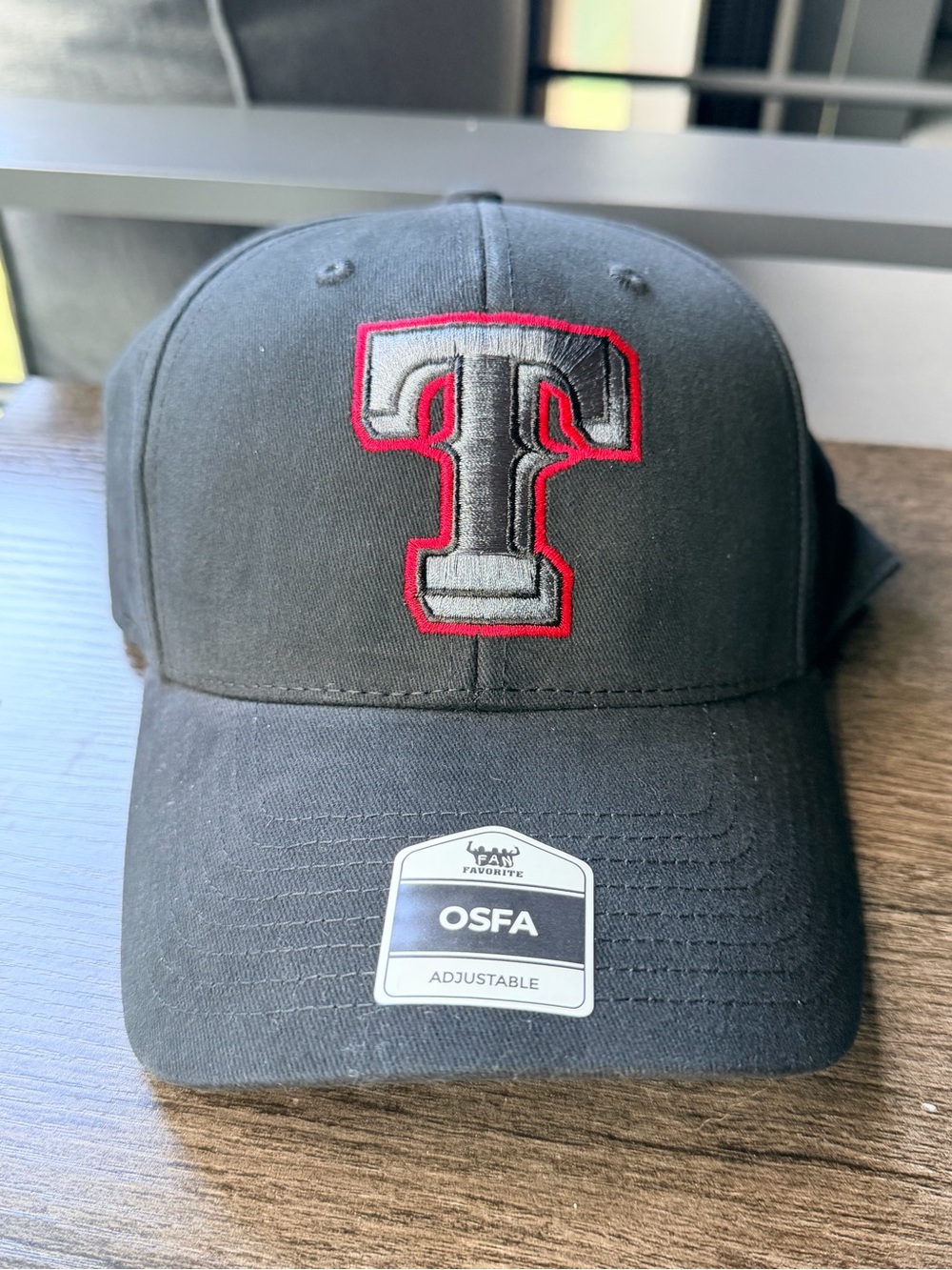 Genuine Merchandise Black Cap with Red and Gray “T” Logo